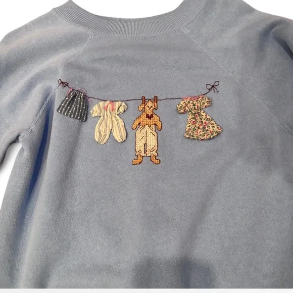 Blue Sweatshirt with Embroidered Clothesline Design - Picture 2 of 3